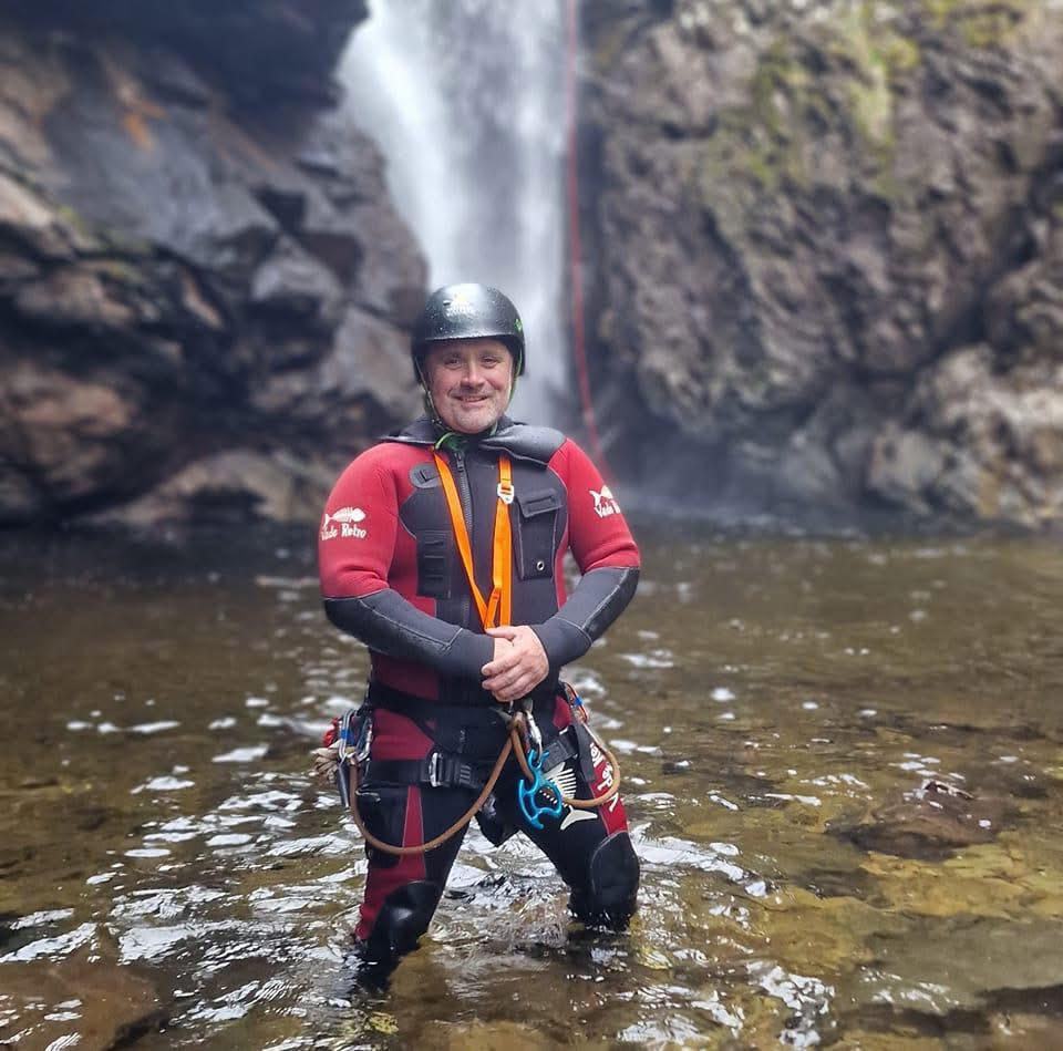 a man standing next to a body of water